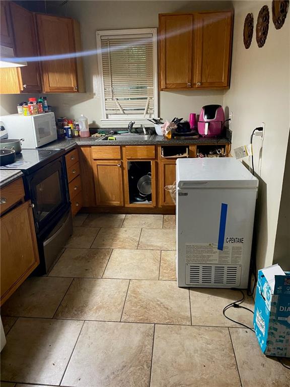 2903 Jadan Place Macon, GA 31206 - Photo 4 of 5 a kitchen with a sink a stove and a microwave oven