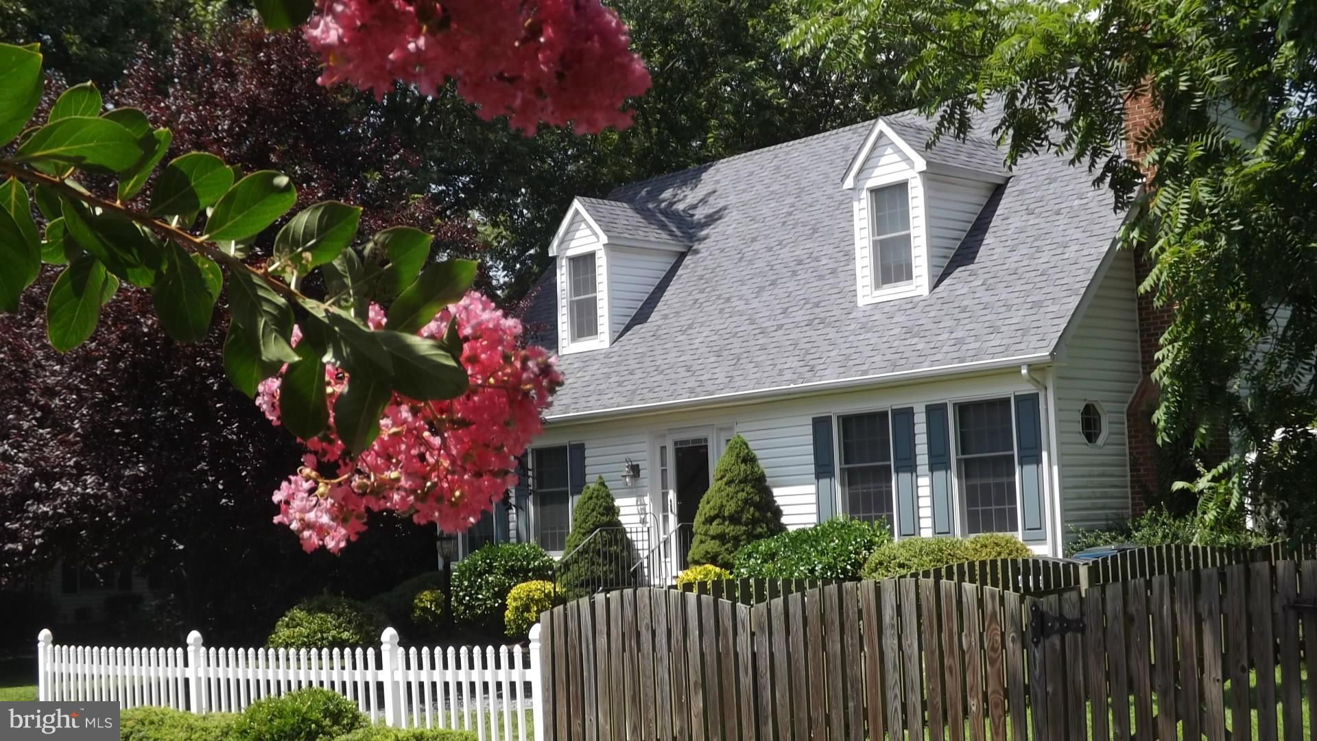 103 Douglas Ln Street St. Michaels, MD 21663 - Photo 1 of 28 a front view of a house with a garden