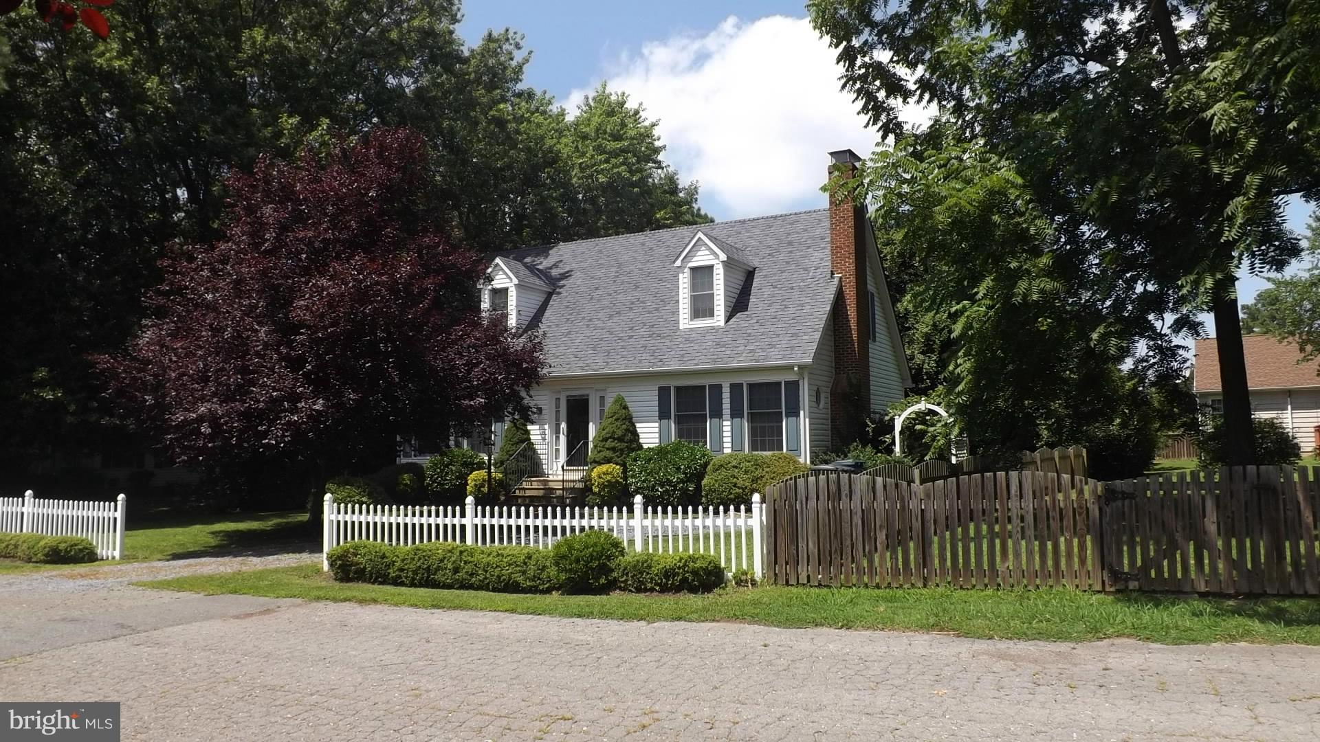 103 Douglas Ln Street St. Michaels, MD 21663 - Photo 23 of 28 a front view of a house with a garden and plants