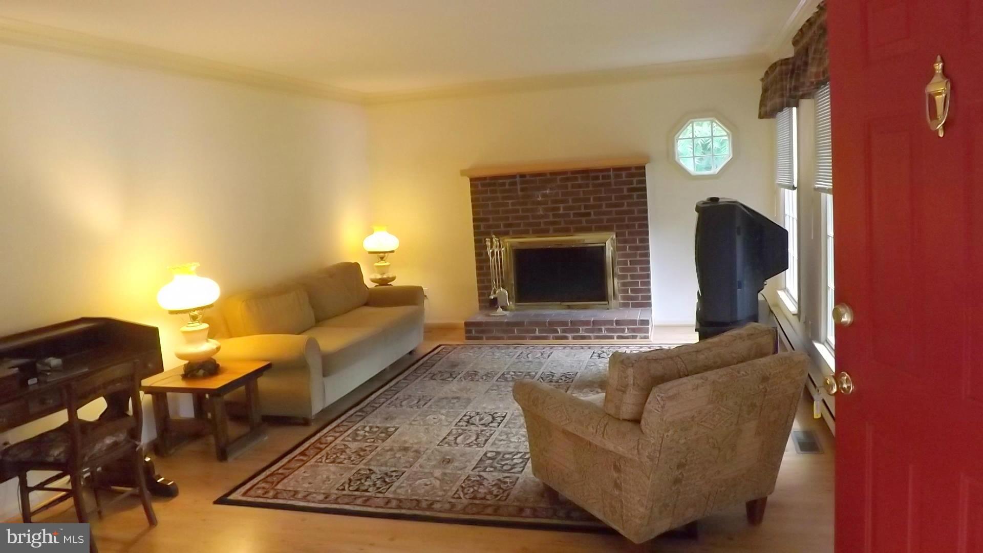 103 Douglas Ln Street St. Michaels, MD 21663 - Photo 9 of 28 a living room with furniture and a fireplace