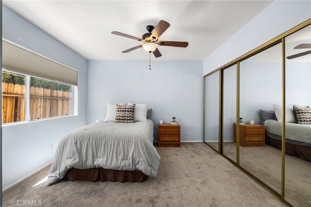 360 Gladys Avenue, Unit 2 Long Beach, CA 90814 - Photo 14 of 22 a bedroom with a bed and a chandelier