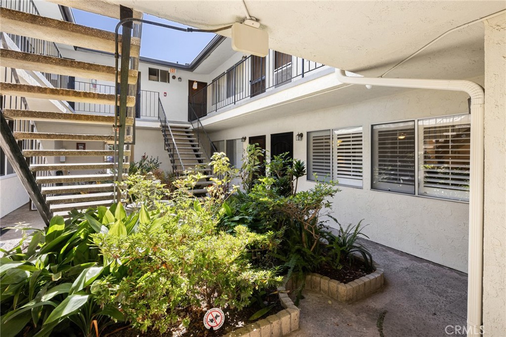 360 Gladys Avenue, Unit 2 Long Beach, CA 90814 - Photo 20 of 22 a flower garden is sitting in front of a house