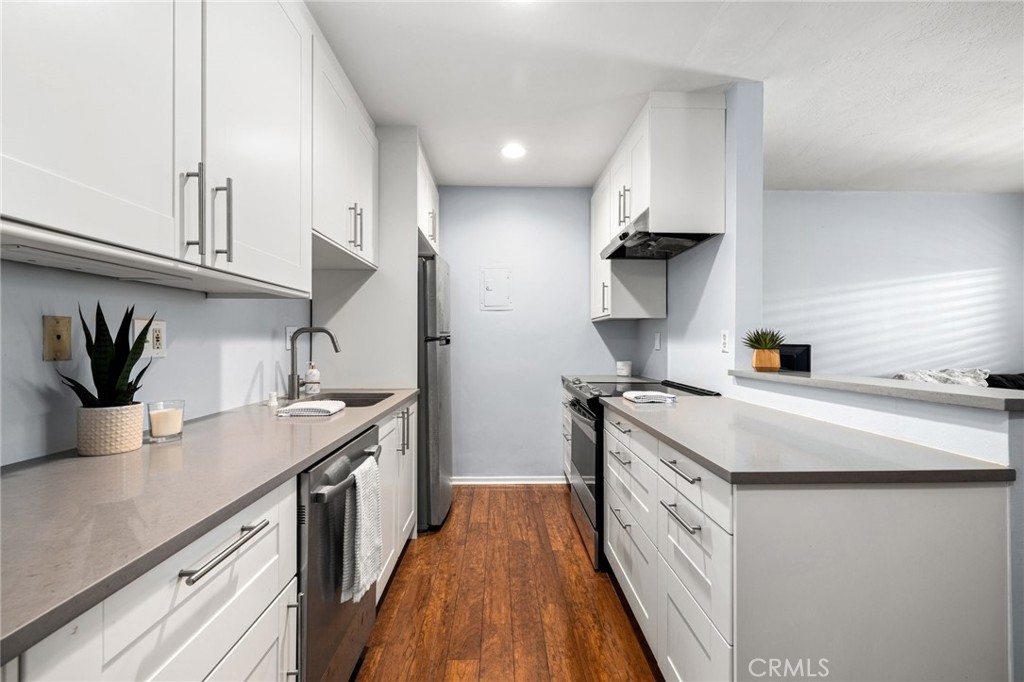 360 Gladys Avenue, Unit 2 Long Beach, CA 90814 - Photo 7 of 22 a kitchen with stainless steel appliances a sink stove and cabinets