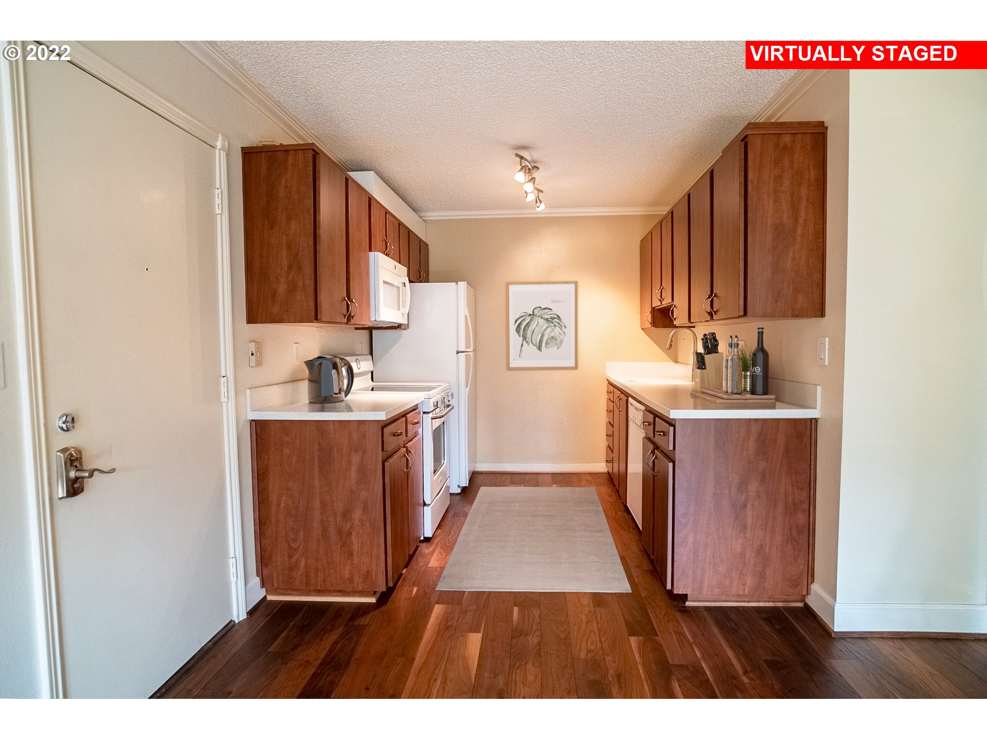 1727 Northeast Multnomah Street, Unit 2 Portland, OR 97232 - Photo 2 of 10 a open kitchen with cabinets and a wooden floor