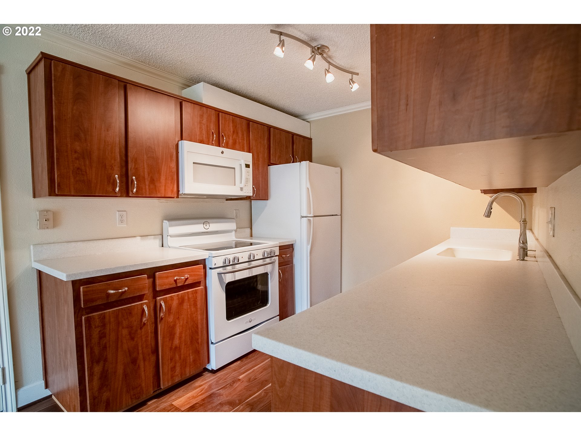 1727 Northeast Multnomah Street, Unit 2 Portland, OR 97232 - Photo 3 of 10 a kitchen with stainless steel appliances a stove a sink and a refrigerator