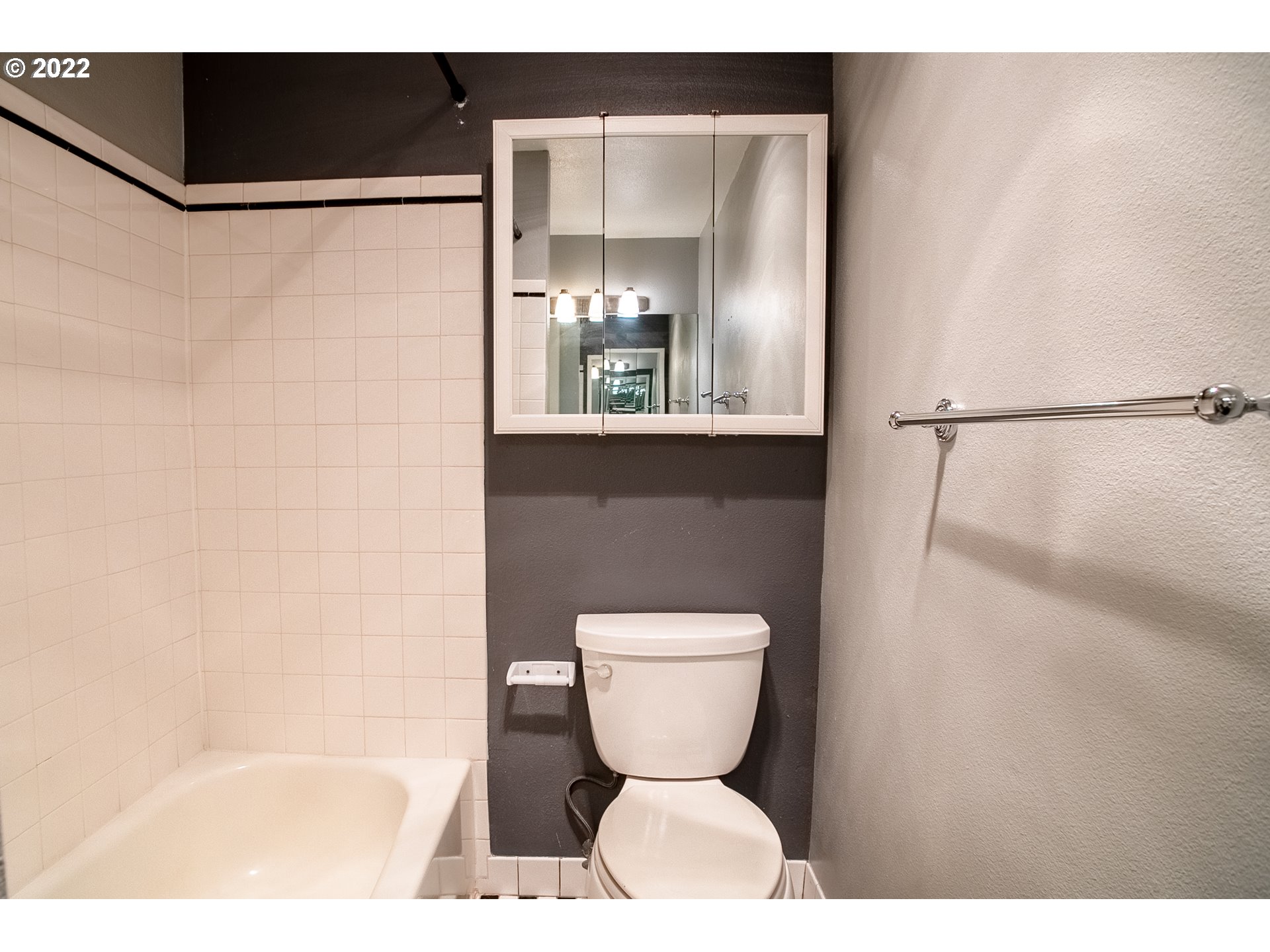 1727 Northeast Multnomah Street, Unit 2 Portland, OR 97232 - Photo 4 of 10 a bathroom with a toilet and a mirror