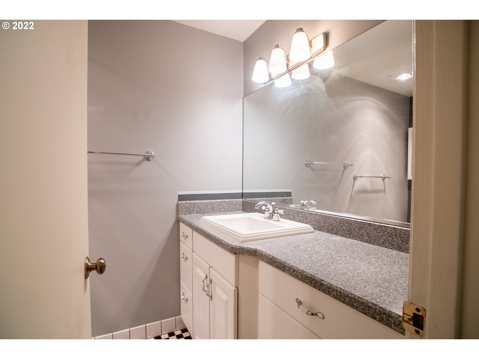 1727 Northeast Multnomah Street, Unit 2 Portland, OR 97232 - Photo 5 of 10 a bathroom with a sink a vanity and a mirror