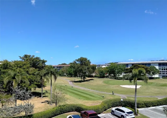 a view of a workspace with furniture and floor to ceiling window