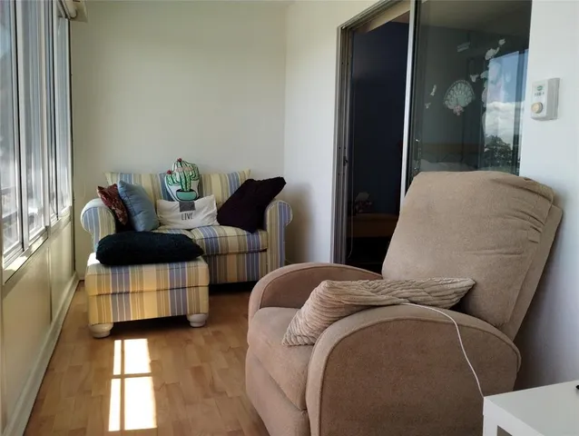a view of empty room with wooden floor and cabinet