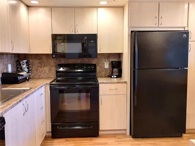 a kitchen with a refrigerator stove and microwave