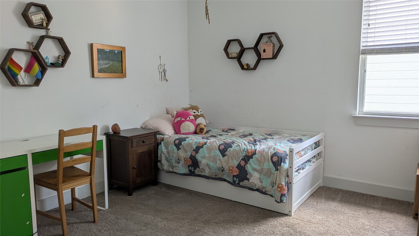 7113 Cherry Beam Path Austin, TX 78744 - Photo 13 of 24 Upstairs bedroom 1