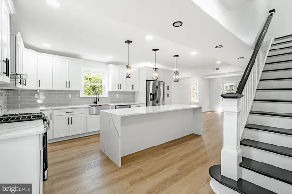 a kitchen with a white wooden cabinets and white appliances