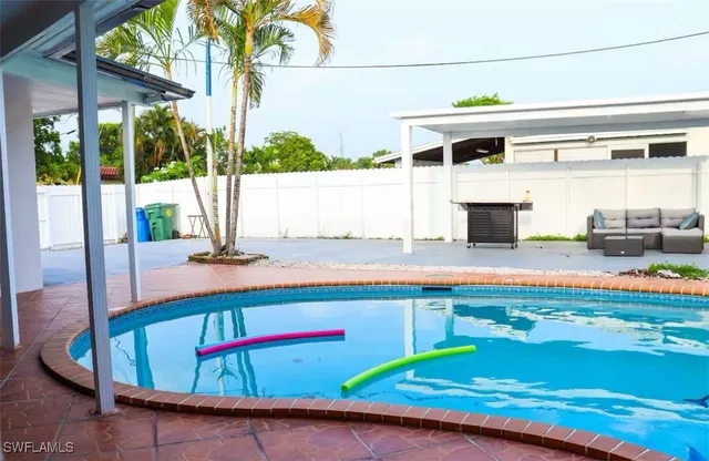 a view of a swimming pool with a patio
