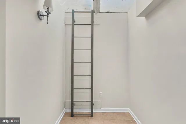 a view of staircase with white walls