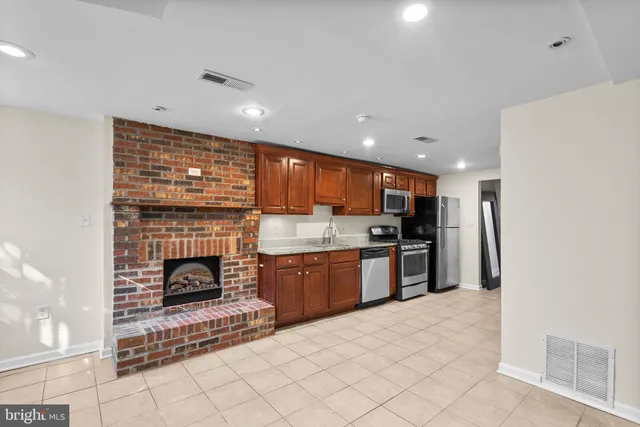 a kitchen with stainless steel appliances granite countertop a refrigerator oven a sink and dishwasher