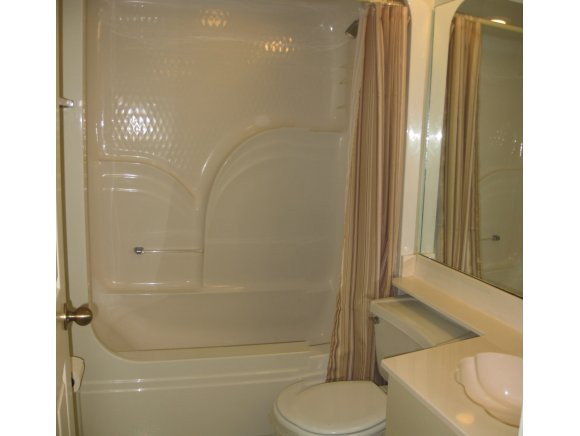 409 Gabriel Circle, Unit 7 Naples, FL 34104 - Photo 12 of 18 a bathroom with a shower and toilet