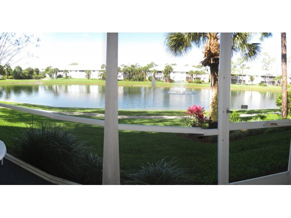 409 Gabriel Circle, Unit 7 Naples, FL 34104 - Photo 13 of 18 a black and white photo of a lake