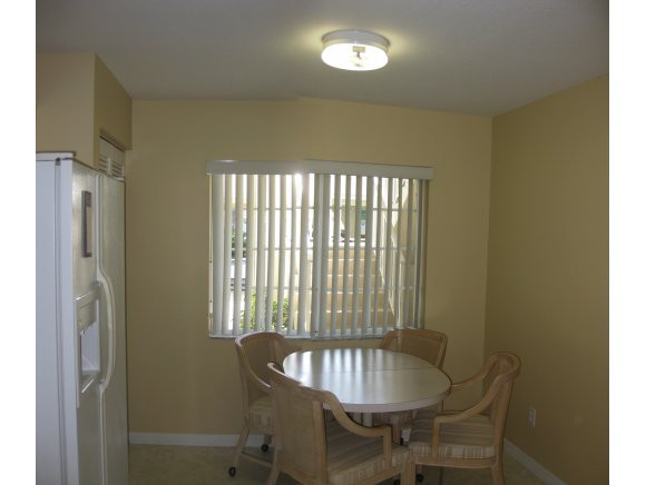 409 Gabriel Circle, Unit 7 Naples, FL 34104 - Photo 5 of 18 a dining room with furniture and window