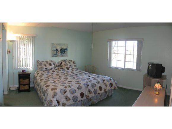409 Gabriel Circle, Unit 7 Naples, FL 34104 - Photo 8 of 18 a bedroom with a bed and a window