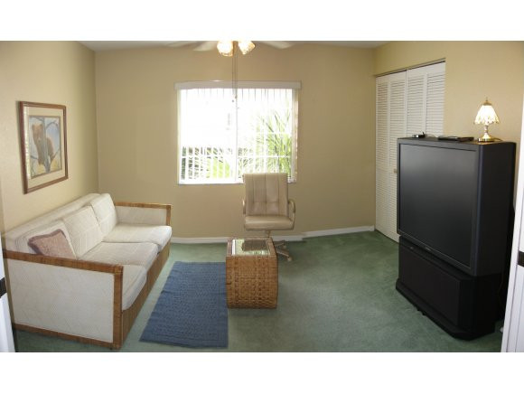 409 Gabriel Circle, Unit 7 Naples, FL 34104 - Photo 10 of 18 a living room with furniture and a window
