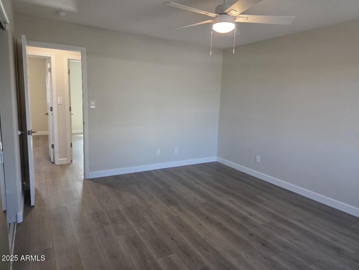 142 West 7th Street Eagar, AZ 85925 - Photo 14 of 25 an empty room with wooden floor and fan