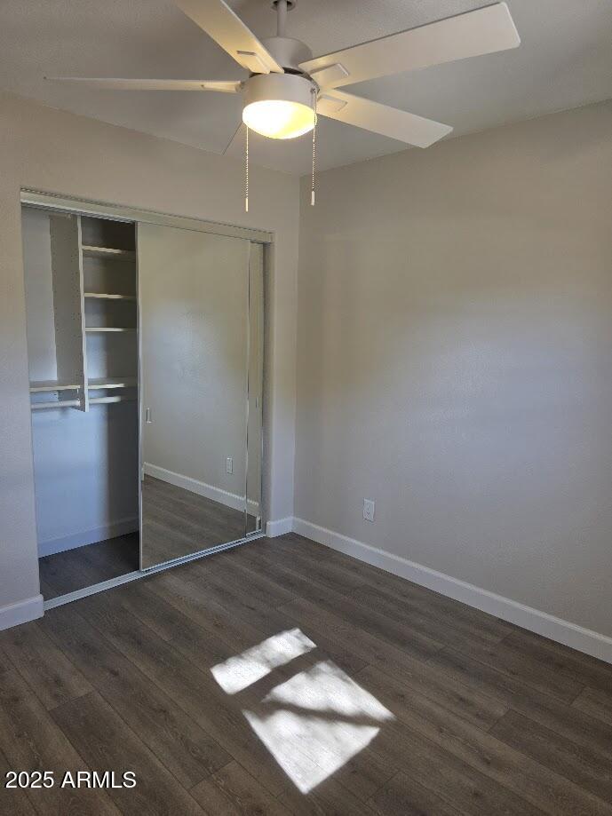 142 West 7th Street Eagar, AZ 85925 - Photo 19 of 25 an empty room with wooden floor cabinet and windows