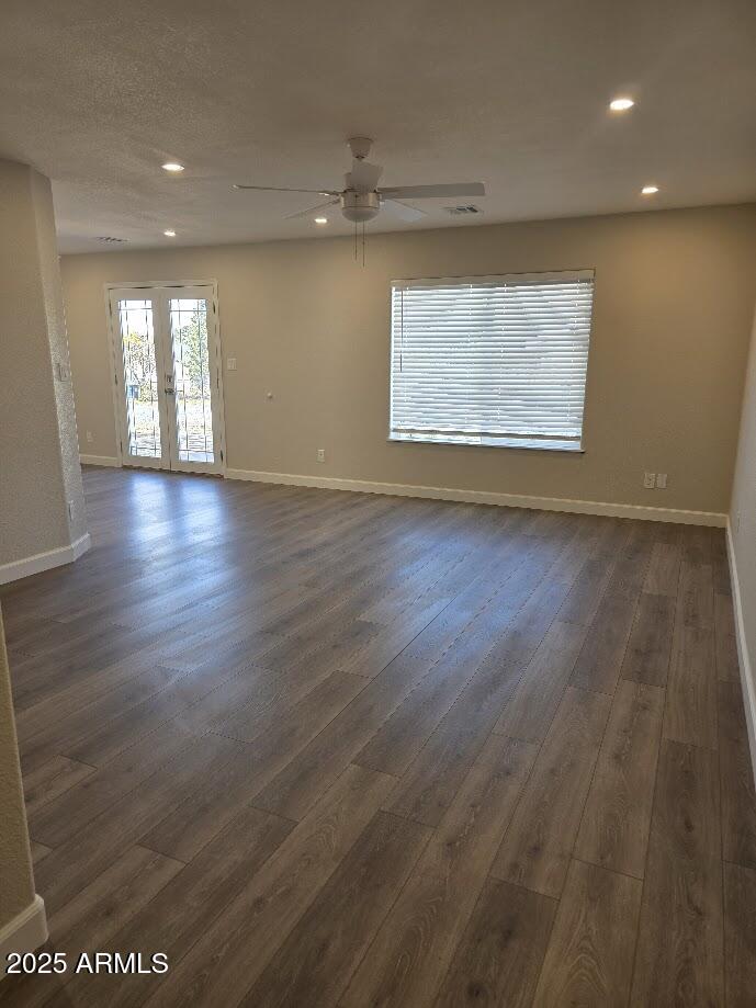 142 West 7th Street Eagar, AZ 85925 - Photo 6 of 25 an empty room with wooden floor cabinet and windows