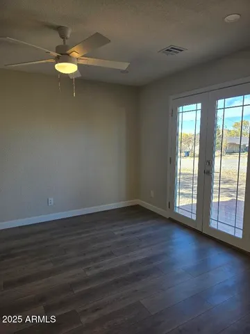 a view of a livingroom with wooden floor and a window
