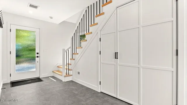 a view of entryway with wooden floor