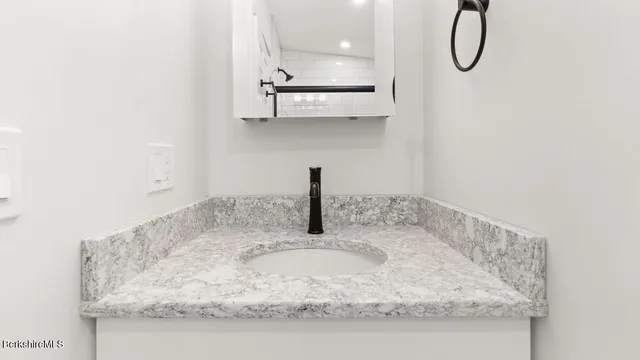 a bathroom with a sink and mirror