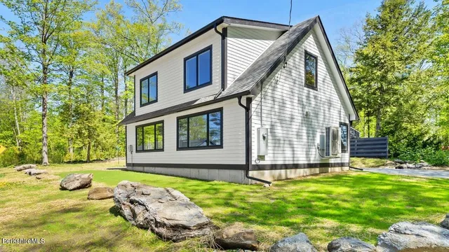 a view of backyard with a garden and swimming pool