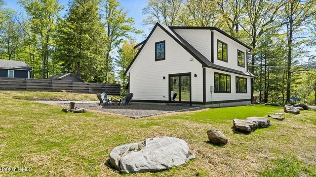 a view of a house with swimming pool and sitting area