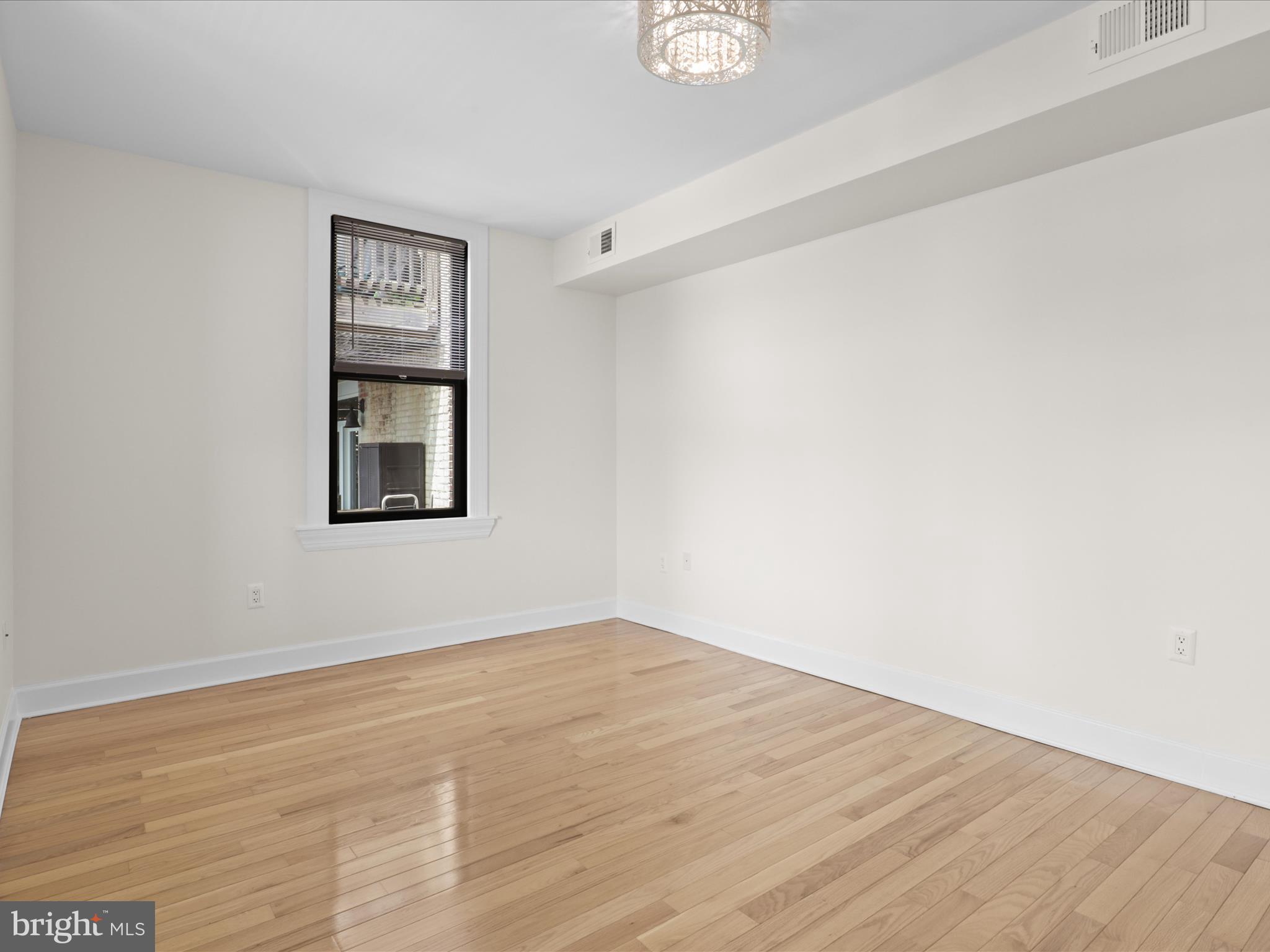 1858 California Street Northwest, Unit 33 Washington, DC 20009 - Photo 18 of 32 a view of empty room with wooden floor and fan