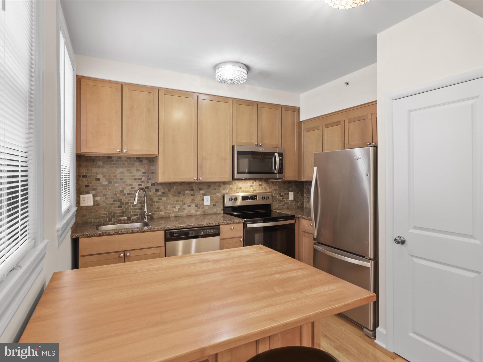 1858 California Street Northwest, Unit 33 Washington, DC 20009 - Photo 10 of 32 a kitchen with stainless steel appliances a refrigerator sink and microwave