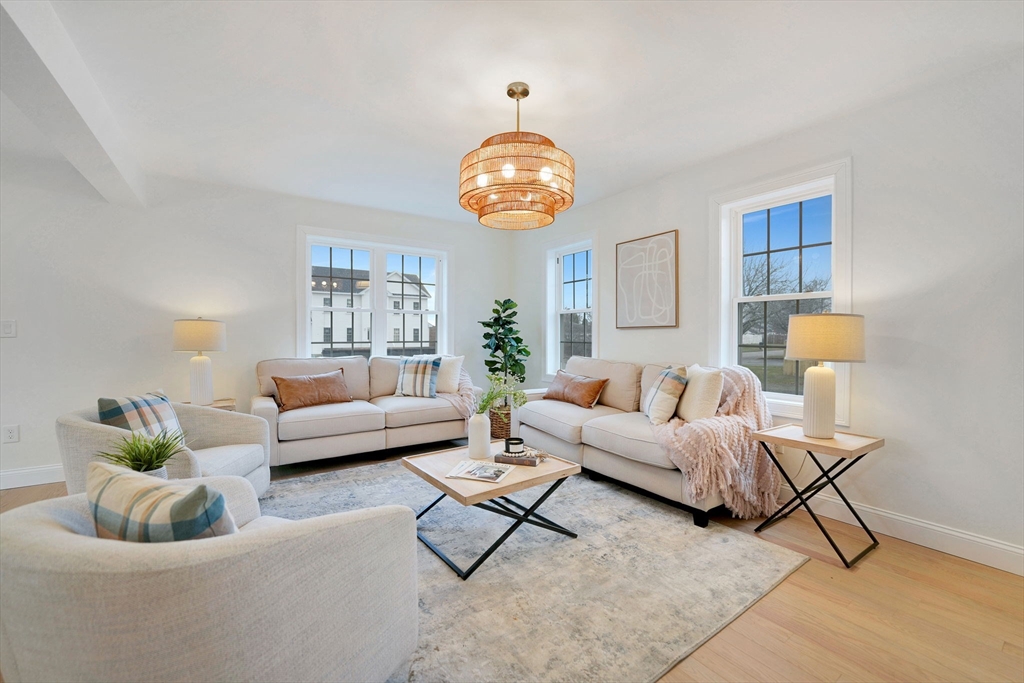 5 Rita's Way Fairhaven, MA 02719 - Photo 5 of 30 a living room with furniture and a chandelier