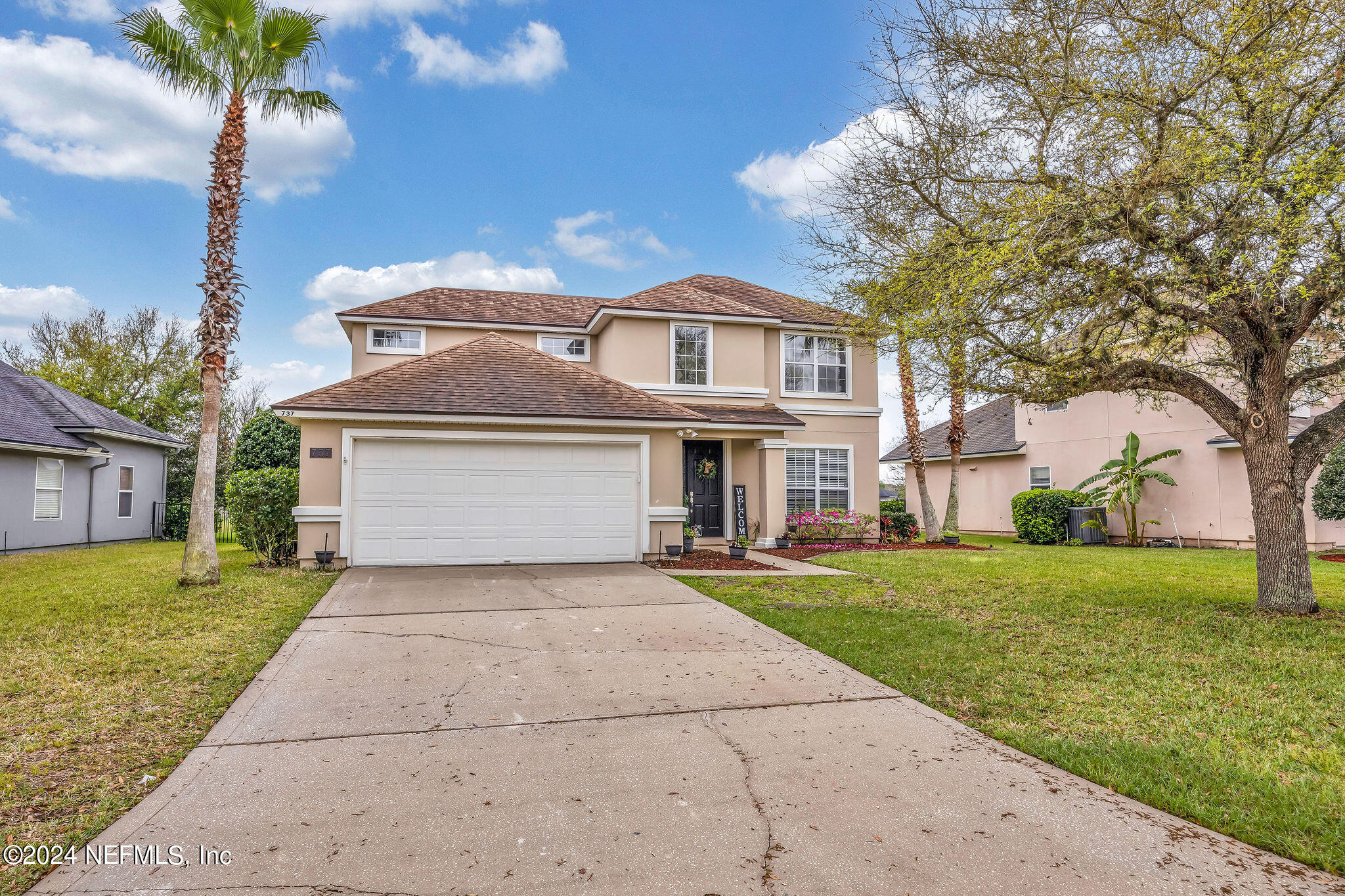 737 Porta Rosa Circle St. Augustine, FL 32092 - Photo 12 of 75 a front view of a house with a yard and garage