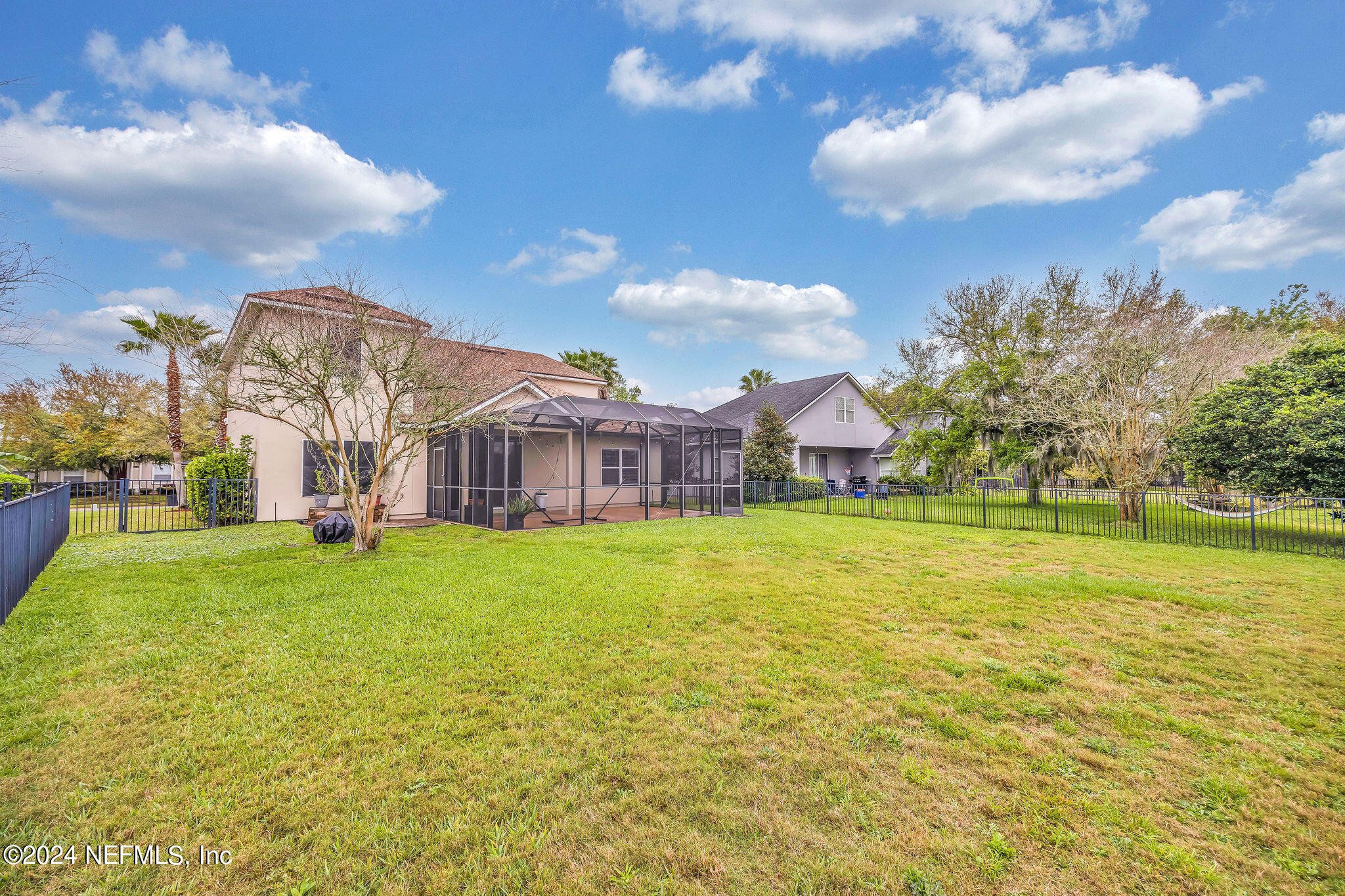737 Porta Rosa Circle St. Augustine, FL 32092 - Photo 19 of 75 a view of a big room with a big yard and large trees