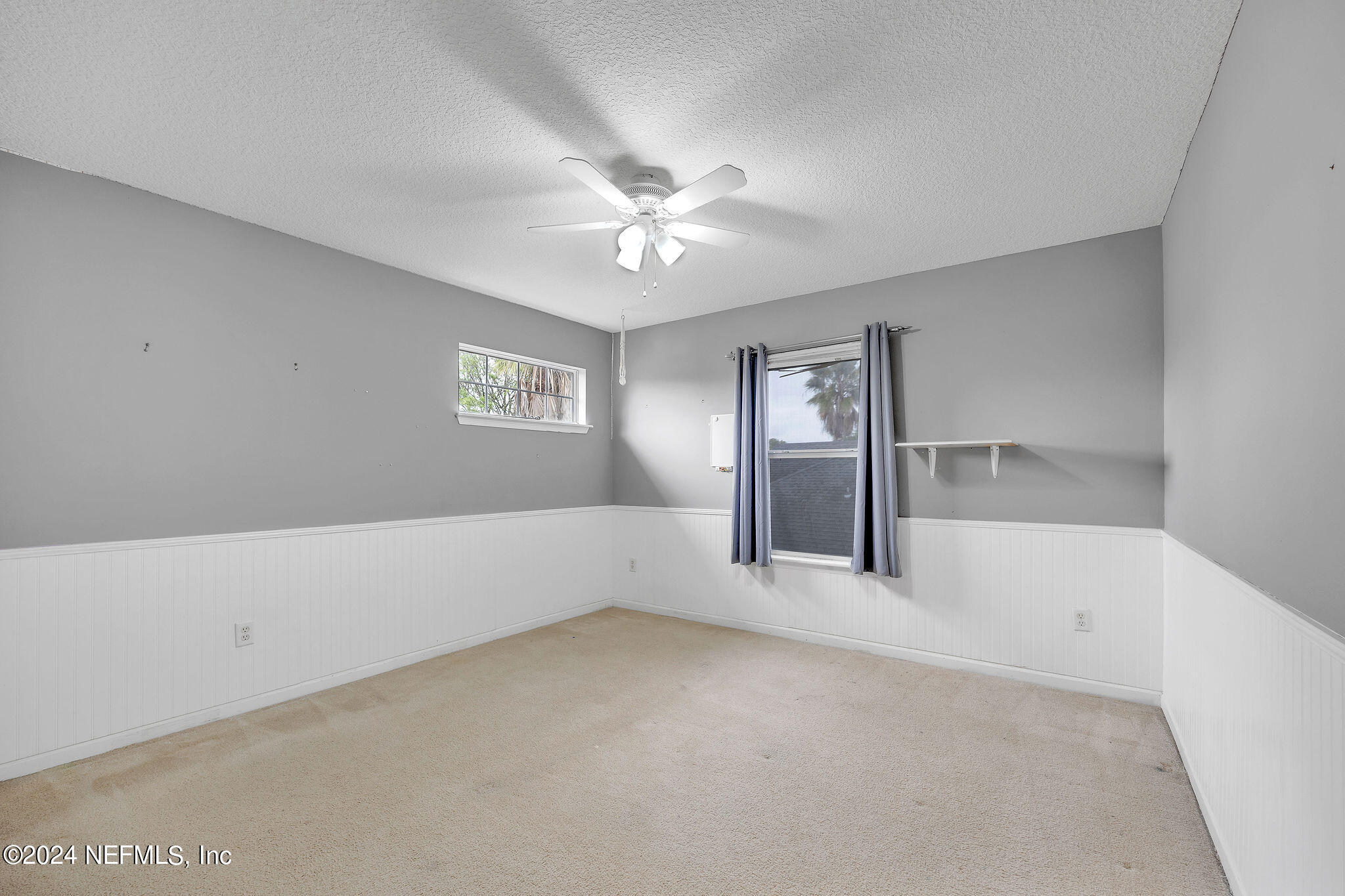 737 Porta Rosa Circle St. Augustine, FL 32092 - Photo 34 of 75 a view of an empty room with window and chandelier fan