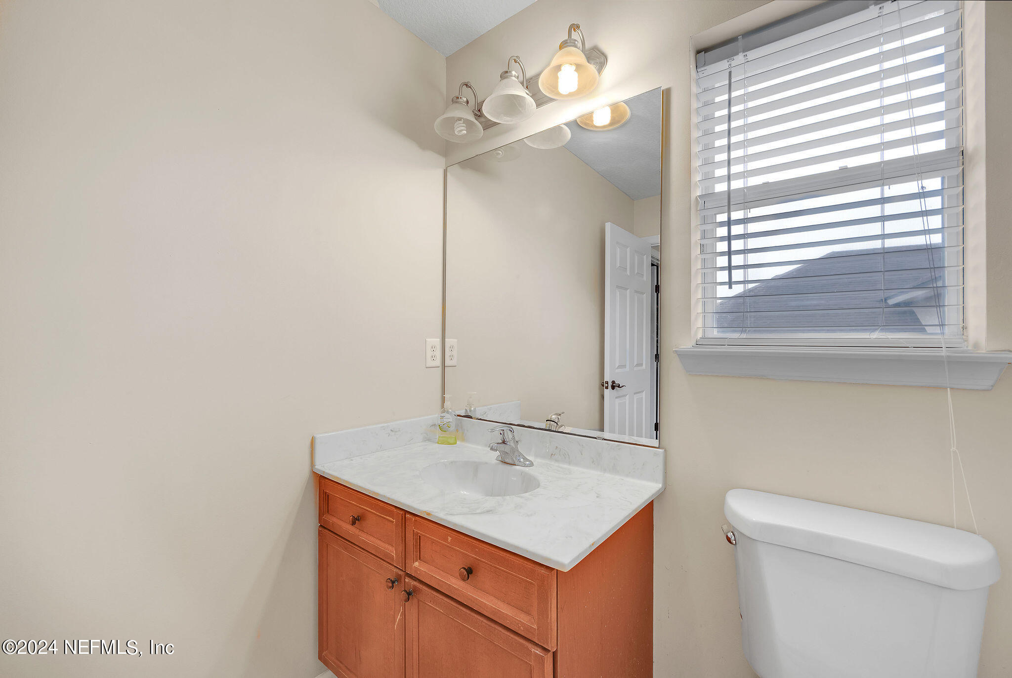 737 Porta Rosa Circle St. Augustine, FL 32092 - Photo 41 of 75 a bathroom with a sink a toilet and a mirror