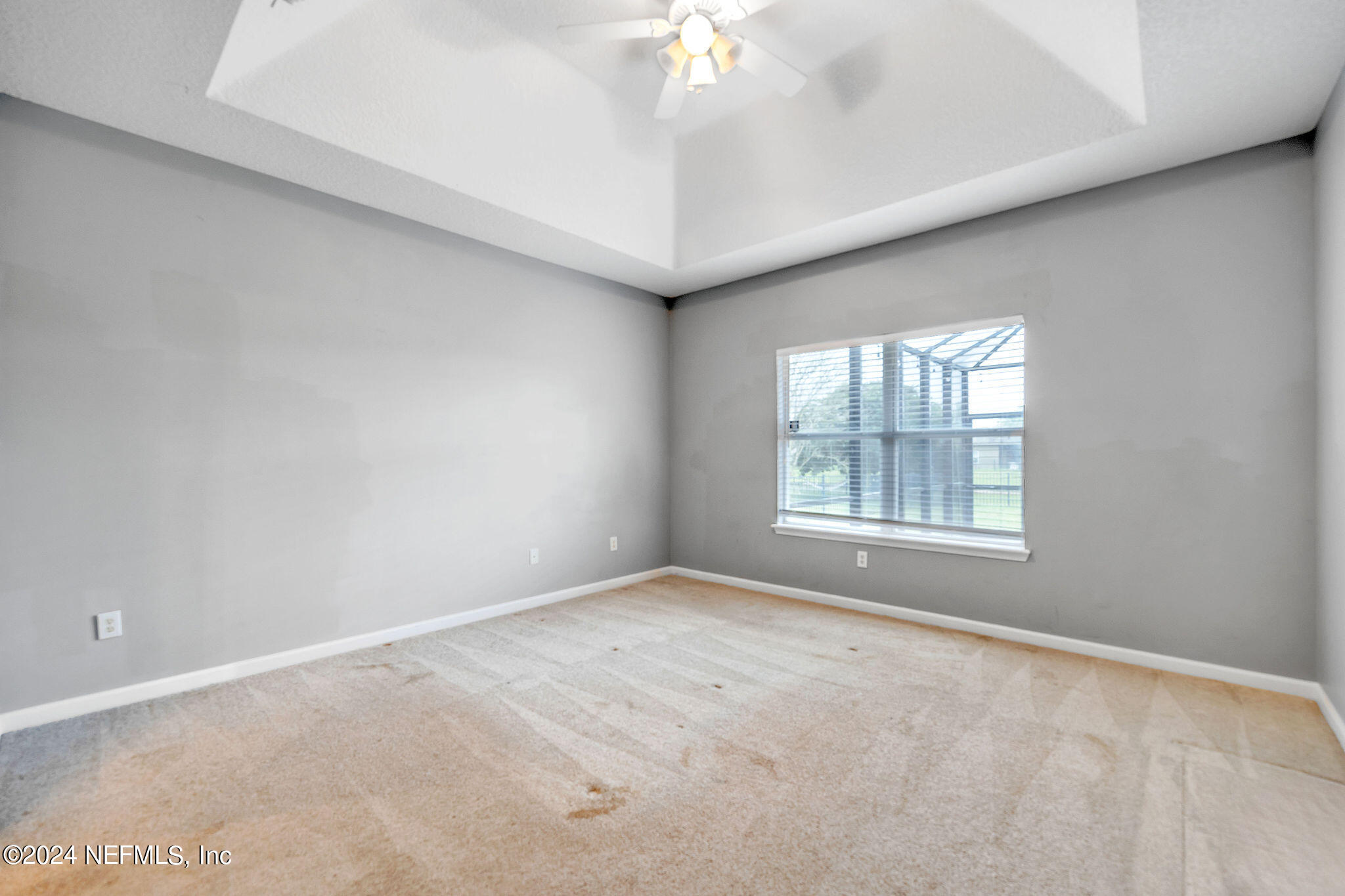737 Porta Rosa Circle St. Augustine, FL 32092 - Photo 60 of 75 an empty room with a chandelier fan and windows