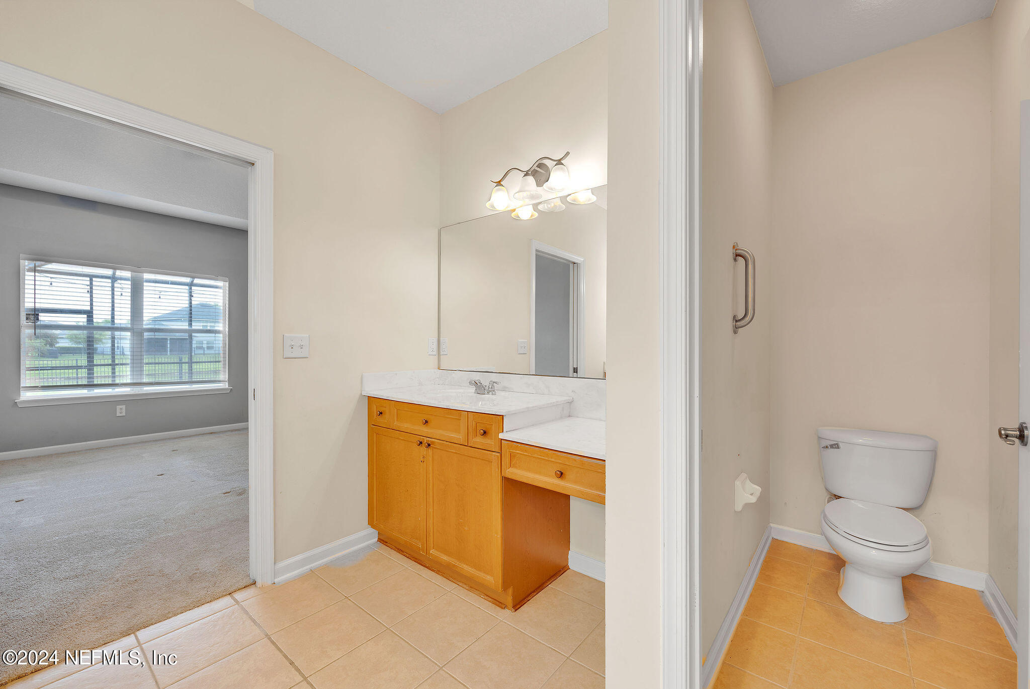 737 Porta Rosa Circle St. Augustine, FL 32092 - Photo 64 of 75 a bathroom with a granite countertop sink mirror vanity and toilet
