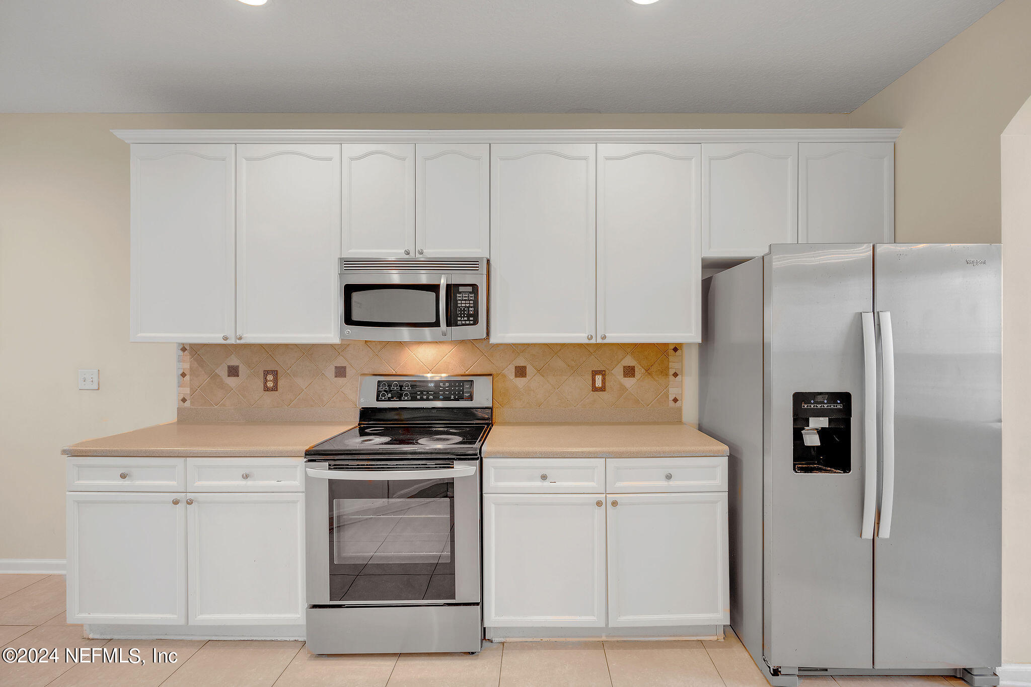 737 Porta Rosa Circle St. Augustine, FL 32092 - Photo 73 of 75 a kitchen with white cabinets and stainless steel appliances