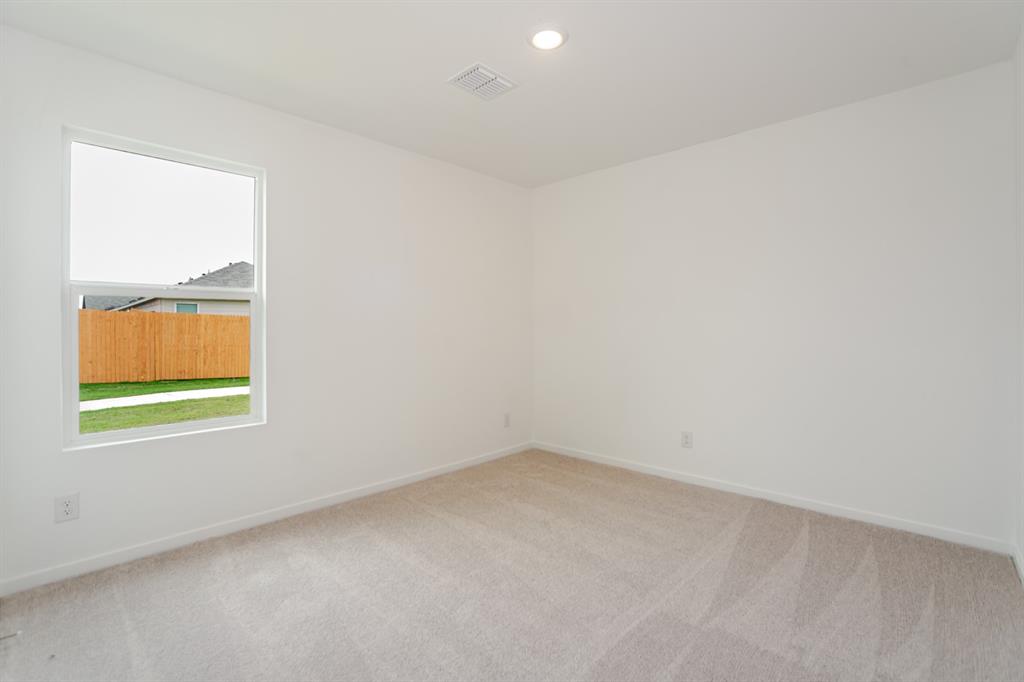 1419 Merlin Blf Street Forney, TX 75126 - Photo 17 of 24 Light-filled room featuring neutral-toned carpeting, white walls, and a single window offering exterior views