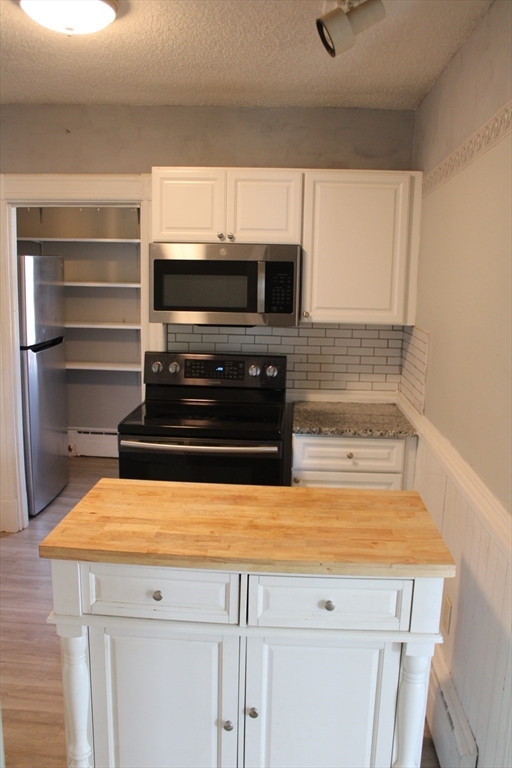 7 State Road Whately, MA 01373 - Photo 12 of 31 a stove top oven sitting inside of a kitchen