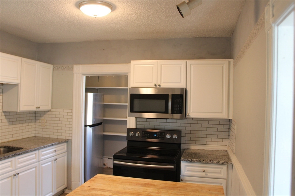 7 State Road Whately, MA 01373 - Photo 9 of 31 a kitchen with a stove and a microwave
