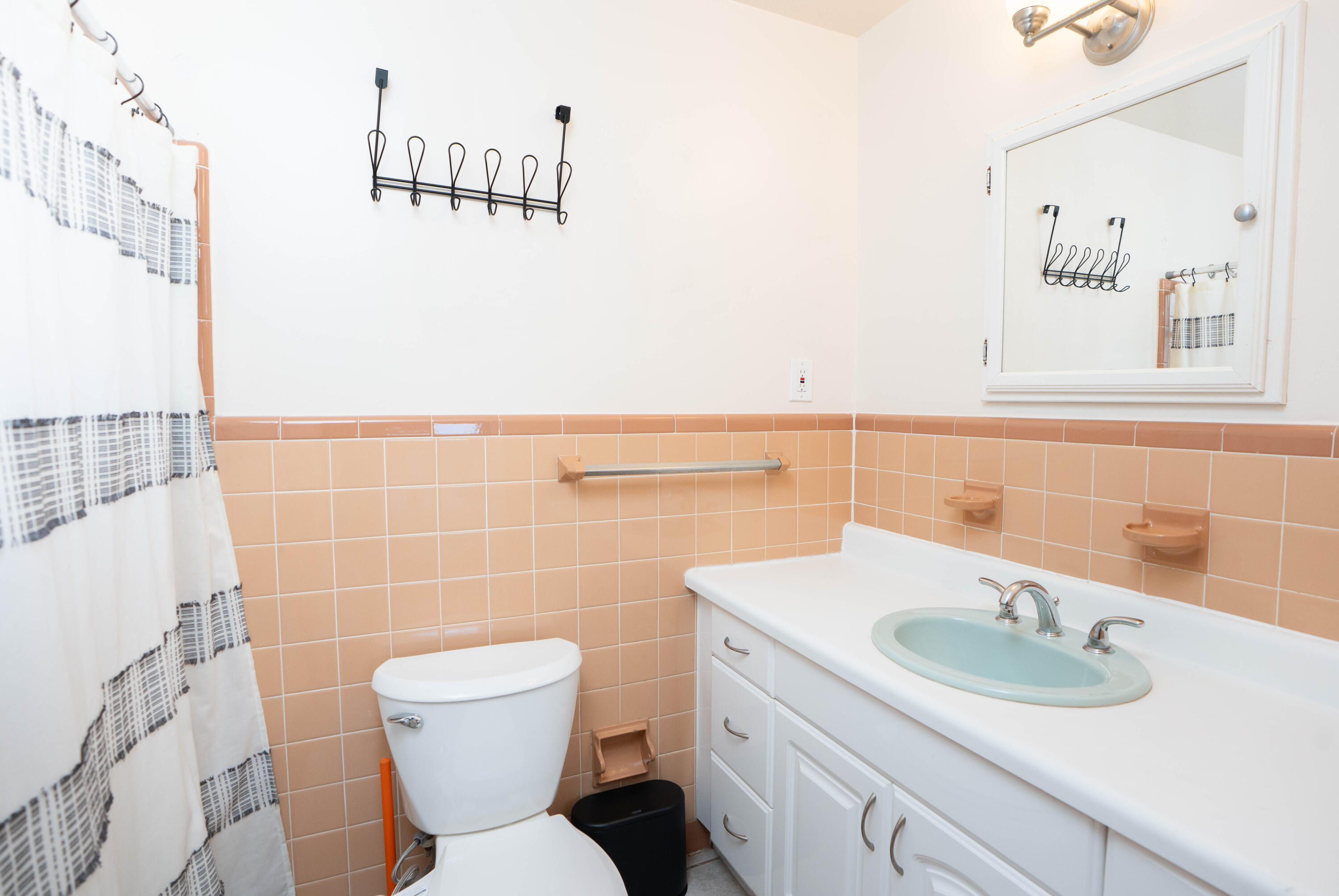 1849 Northwest Pine Tree Way Stuart, FL 34994 - Photo 15 of 29 a bathroom with a sink a toilet and a mirror