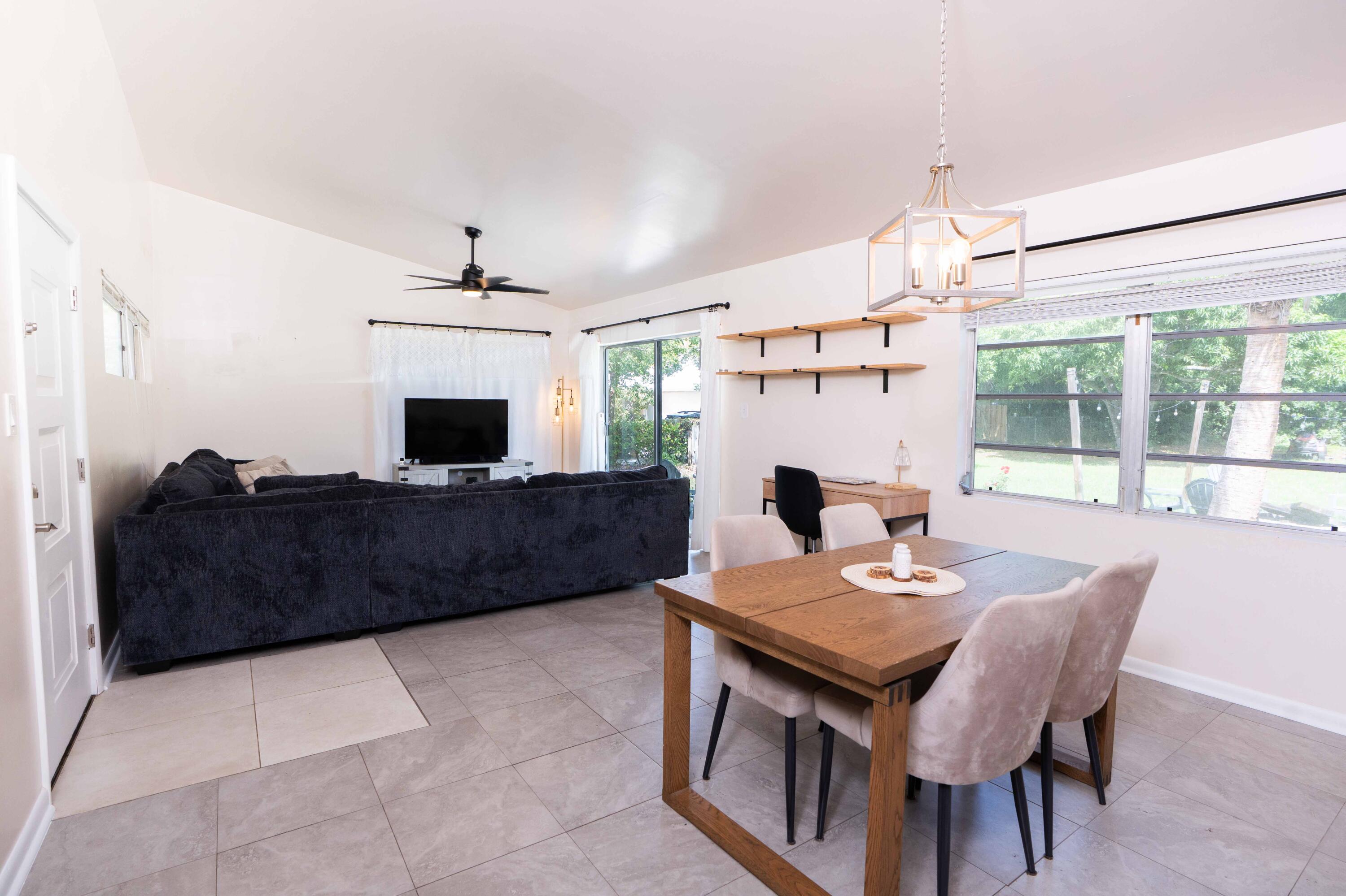 1849 Northwest Pine Tree Way Stuart, FL 34994 - Photo 2 of 29 a view of a dining room with furniture window and wooden floor