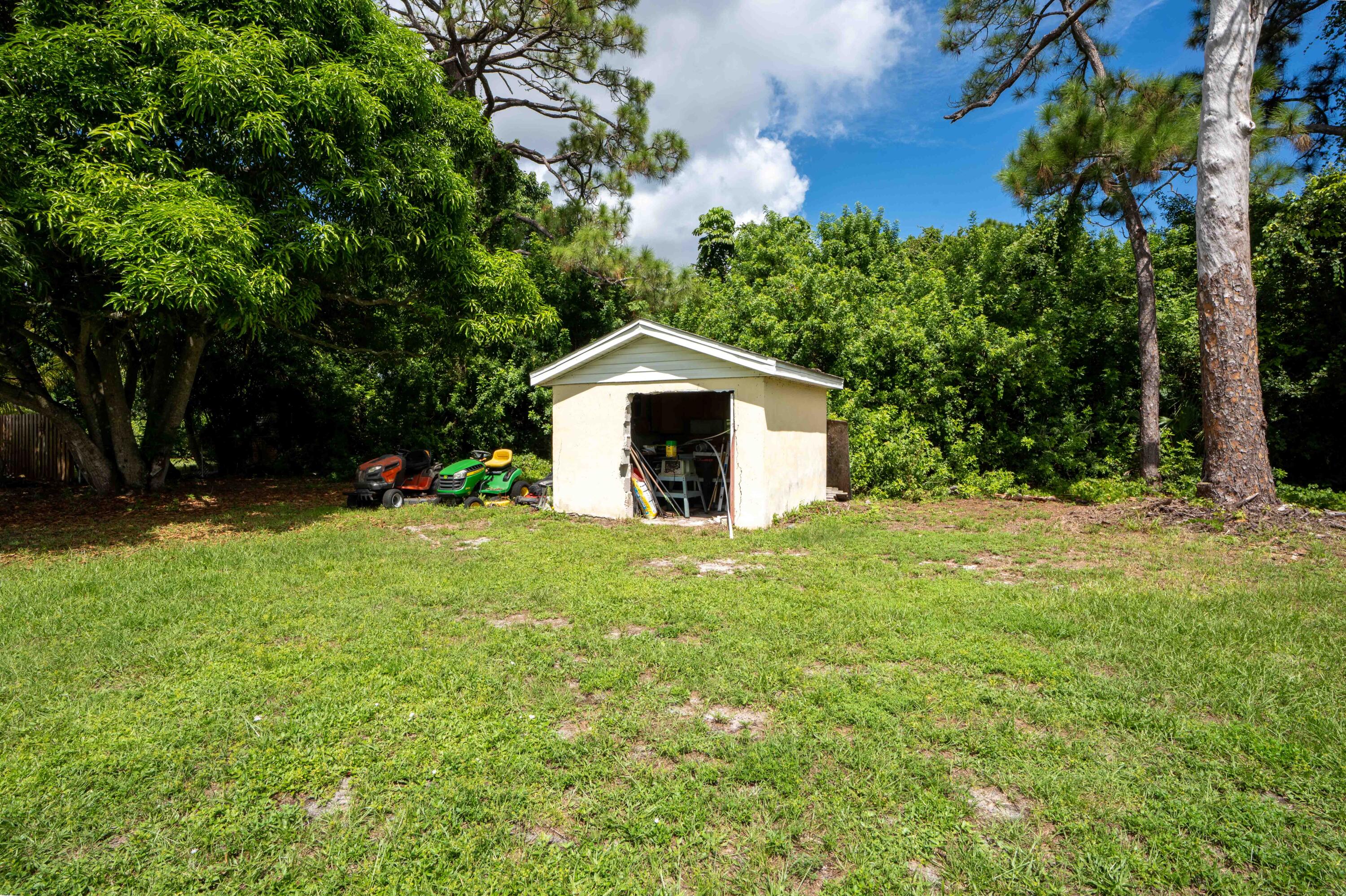 1849 Northwest Pine Tree Way Stuart, FL 34994 - Photo 22 of 29 a view of a house with a yard and tree s