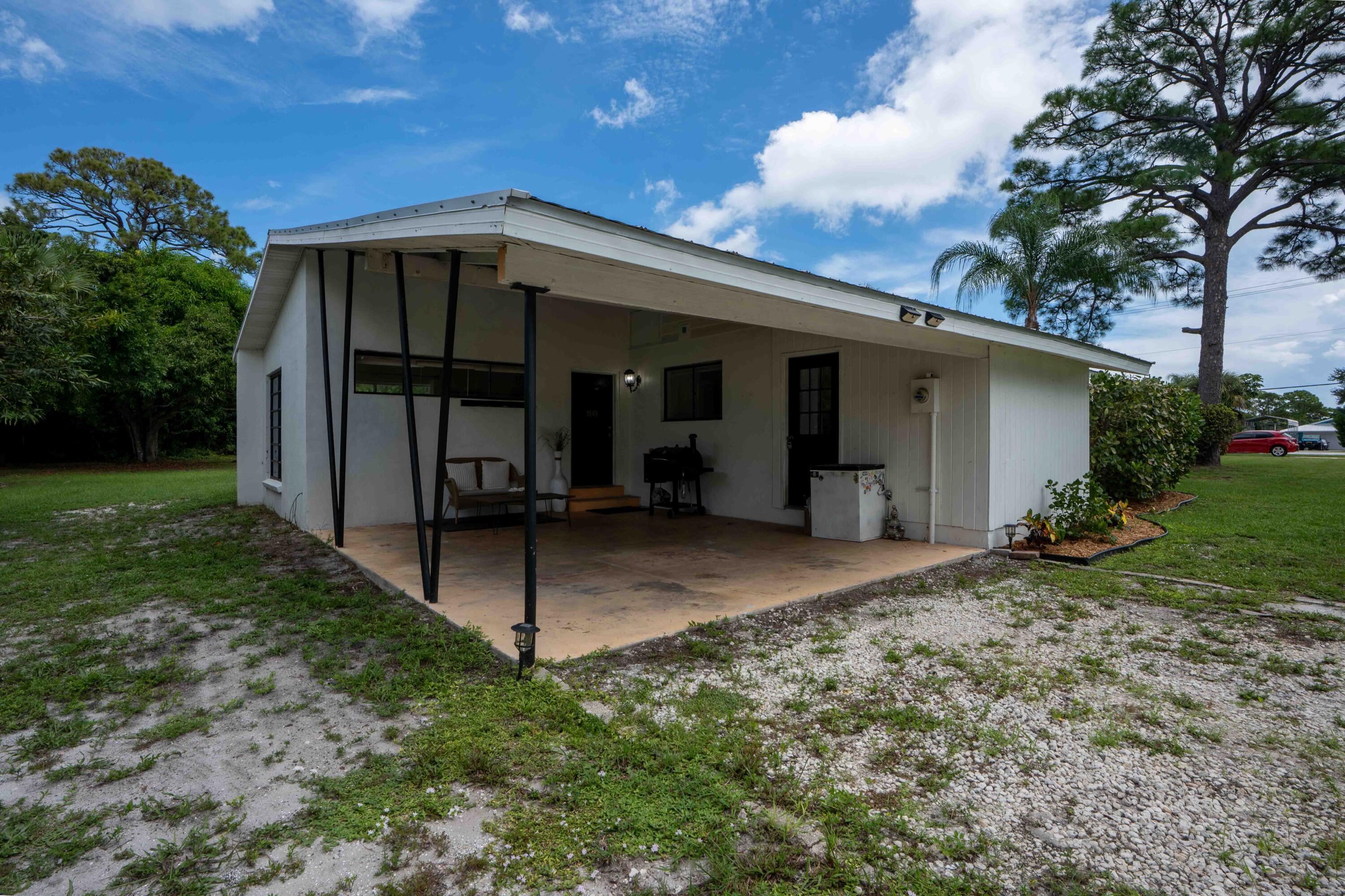 1849 Northwest Pine Tree Way Stuart, FL 34994 - Photo 25 of 29 a view of a house with backyard and entertaining space