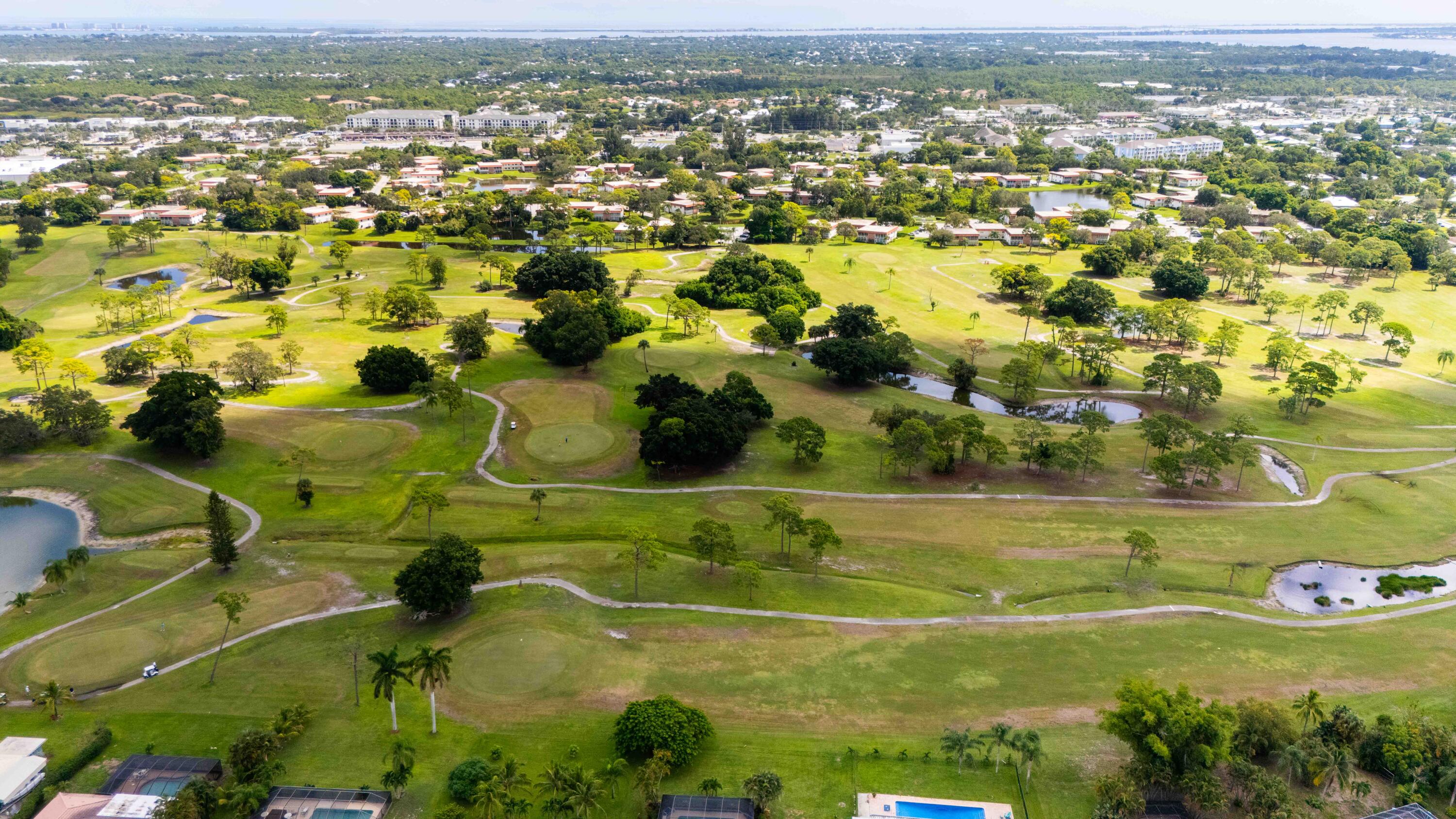 1849 Northwest Pine Tree Way Stuart, FL 34994 - Photo 27 of 29 an aerial view of residential houses with outdoor space